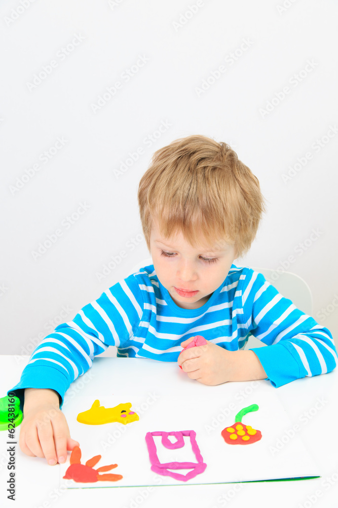 little boy playing with clay dough little boy playing with clay dough