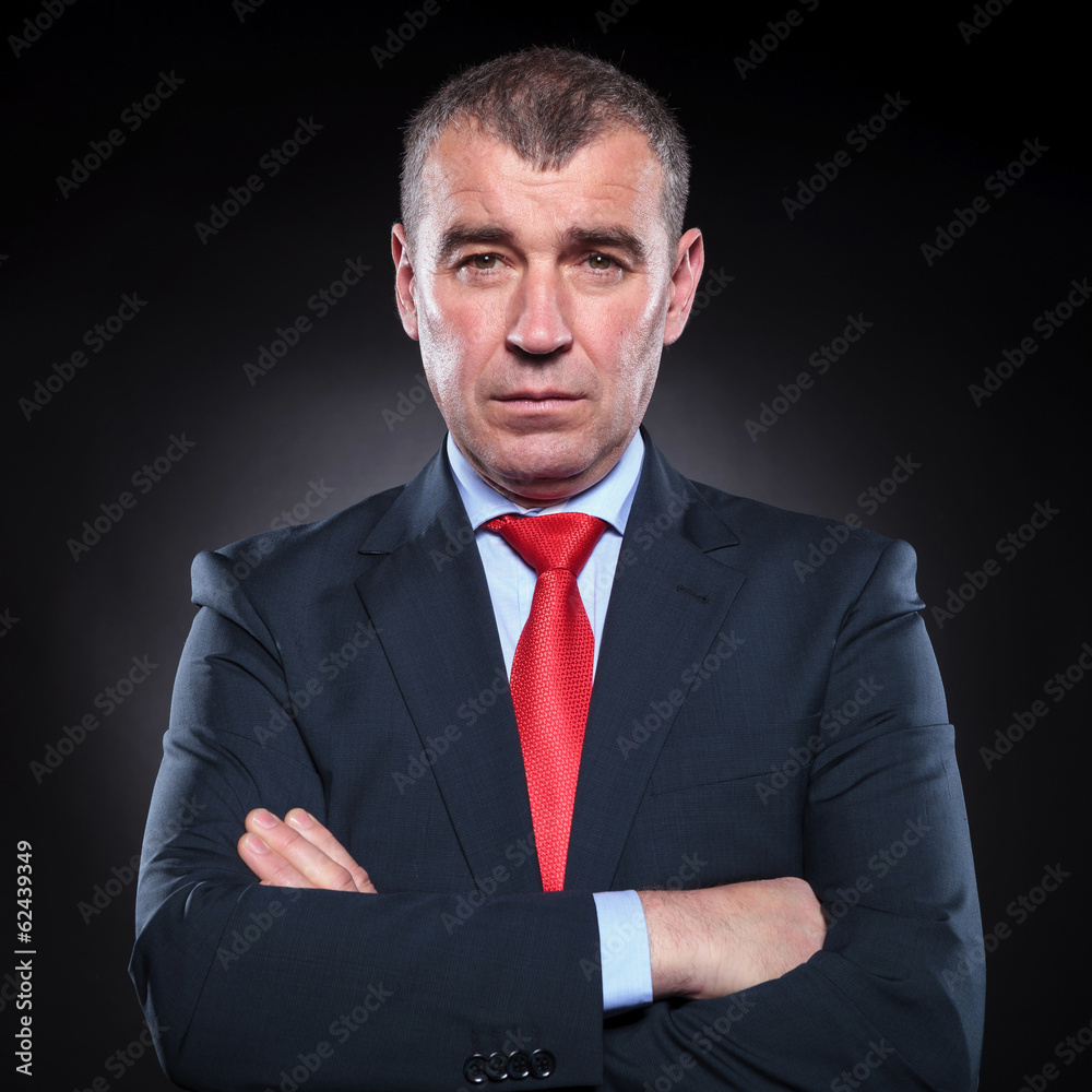 serious mature business man with hands folded serious mature business man with hands folded