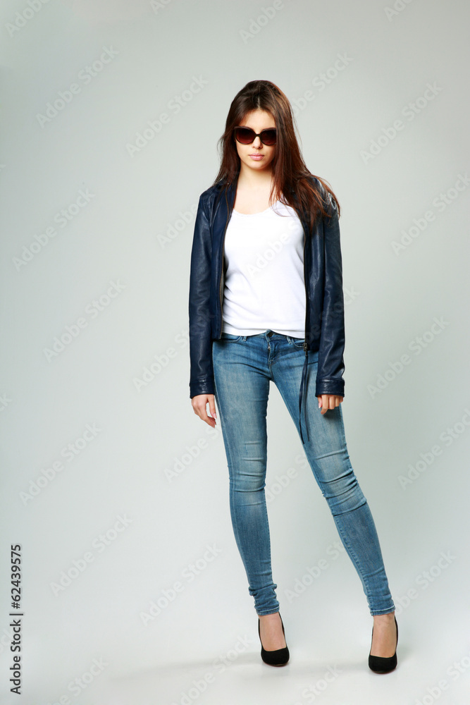 model in leather jacket and sunglasses on gray background model in leather jacket and sunglasses on gray background