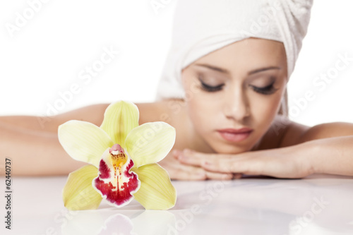 young girl with the towel on her head posing with orchid