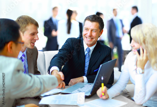 Business people shaking hands, finishing up a meeting photo