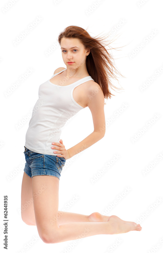 Girl in a white shirt and blue shorts on a white background. Girl in a white shirt and blue shorts on a white background.