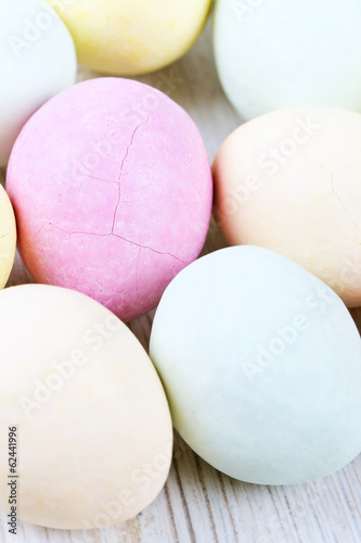 marcipan eggs on white wooden surface