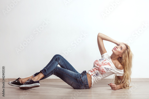 Attractive Sexy Young Blonde Woman Posing in Jeans Denim Casual