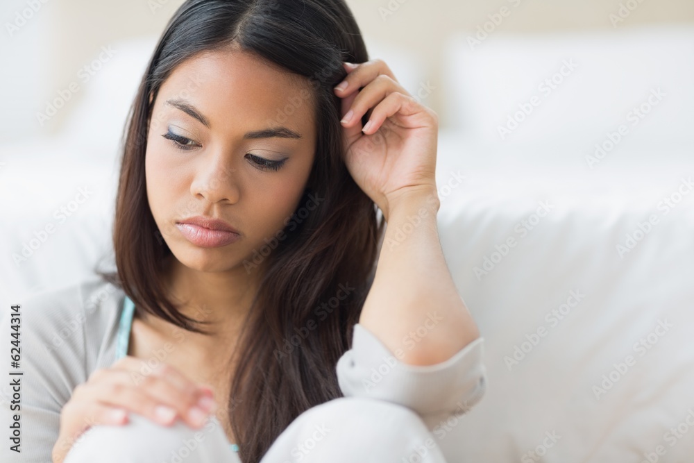 Upset girl sitting on the floor