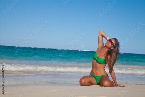 Long haired girl in bikini on tropical Hawaiian beach