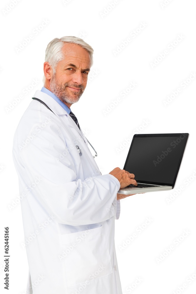 Portrait of a content male doctor using laptop Portrait of a content male doctor using laptop