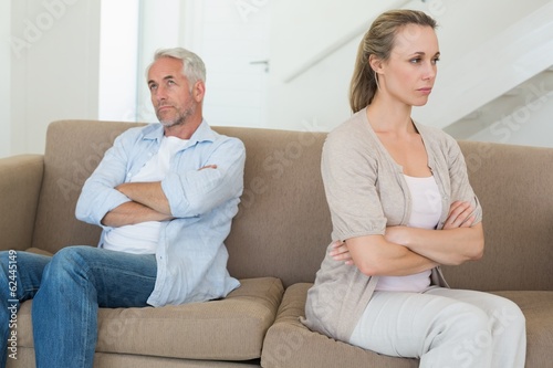 Angry couple sitting on couch not talking to each other