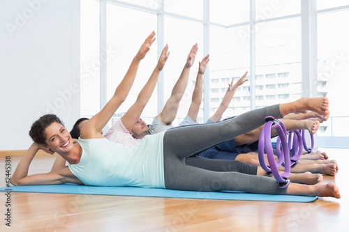 Class stretching legs and hands in row at yoga class