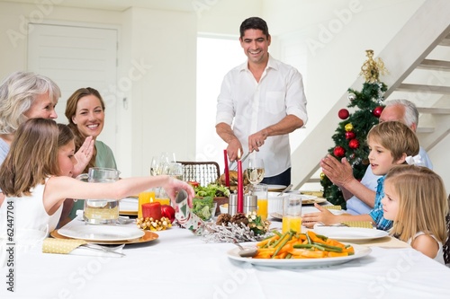 Family enjoying Christmas meal at dining table