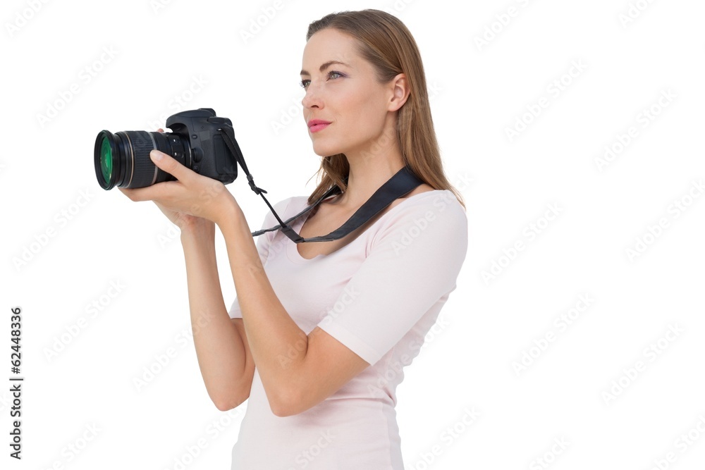 Side view of a young woman with camera