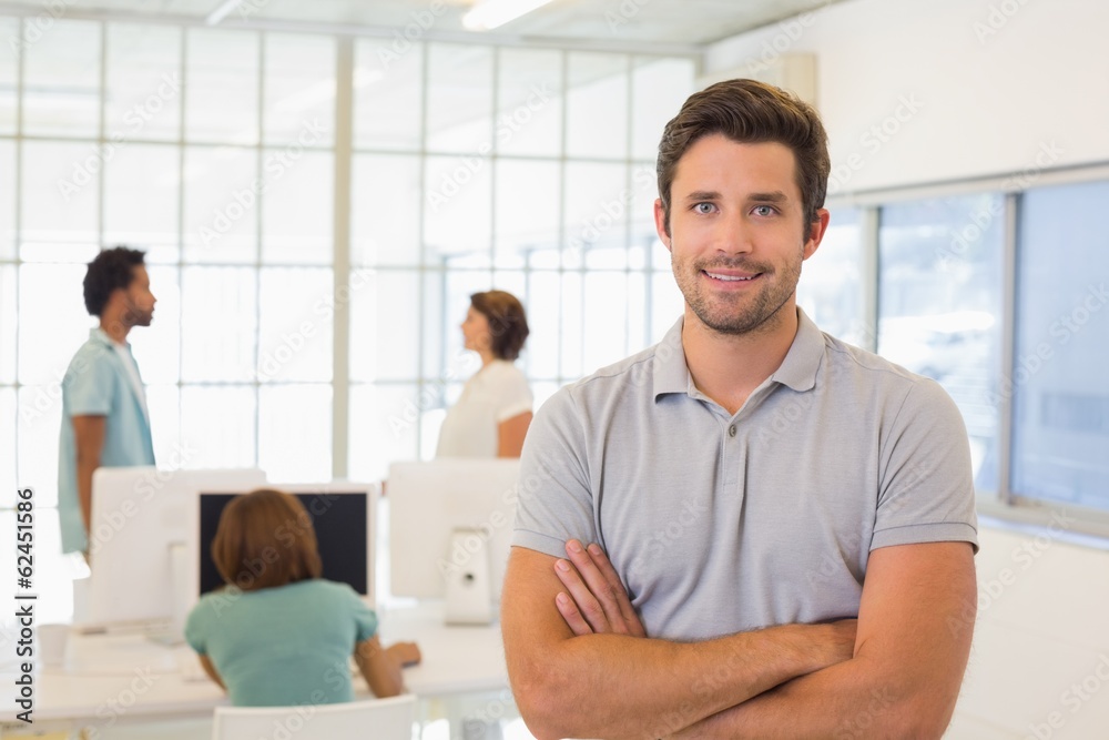 Obraz premium Portrait of a smiling businessman with colleagues in meeting