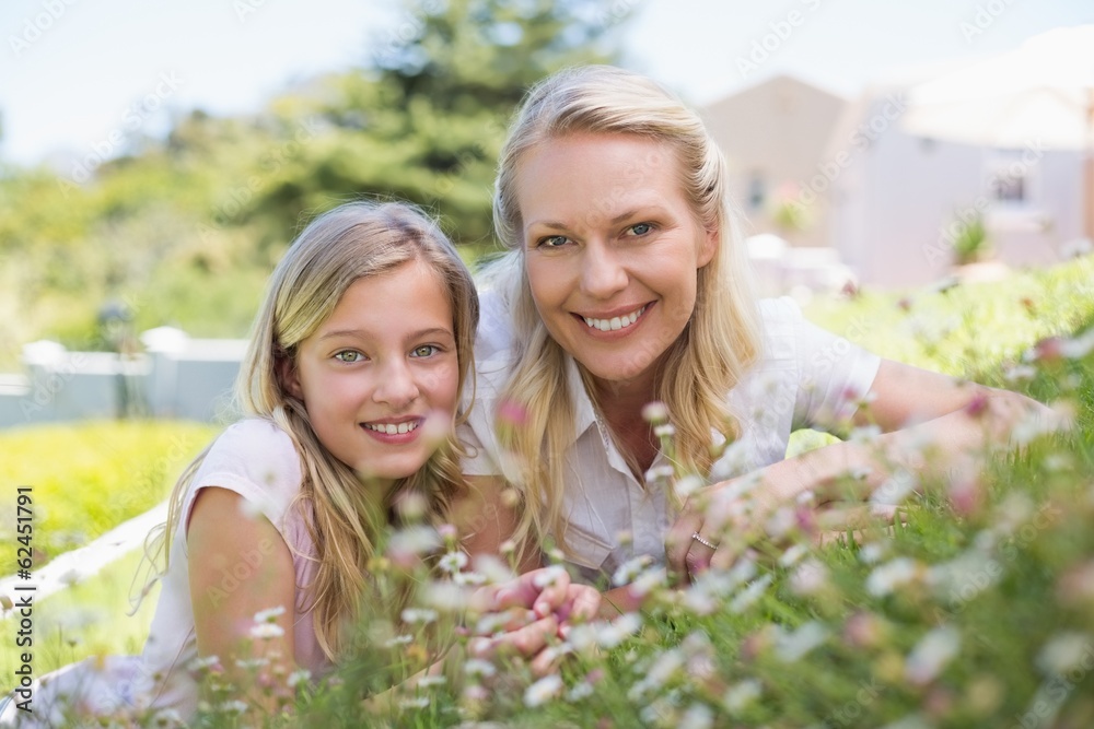 Happy mother and daughter lying in park Happy mother and daughter lying in park