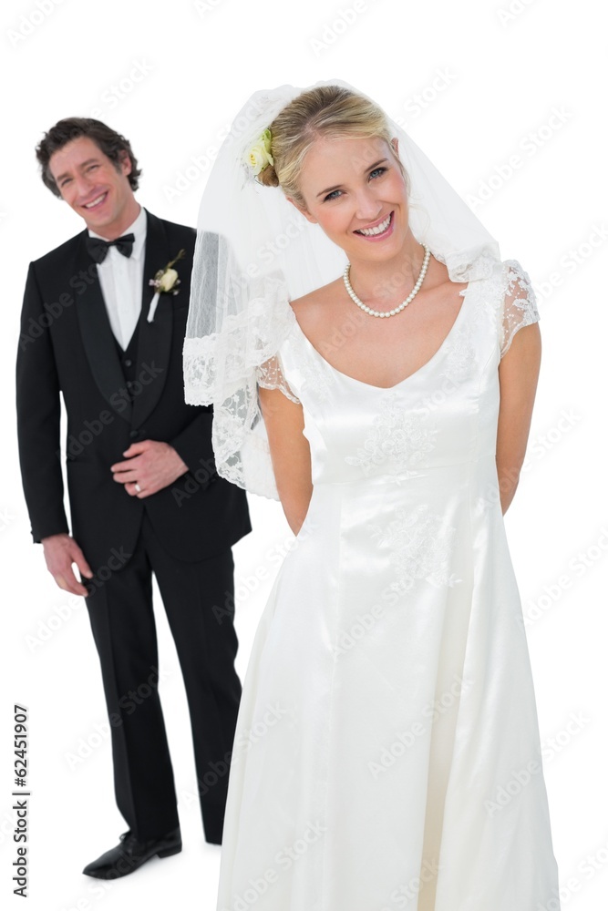 Bride standing with groom over white background