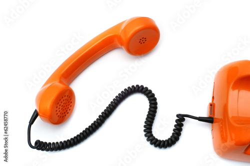 Orange telephone hotline with old retro phone receiver on white background