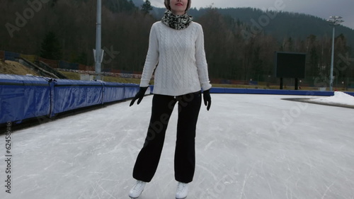 woman figure skating at an open outdoor speed skating rink appro photo