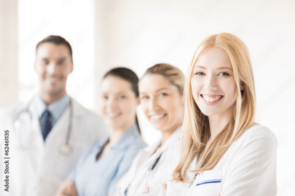 female doctor in front of medical group female doctor in front of medical group