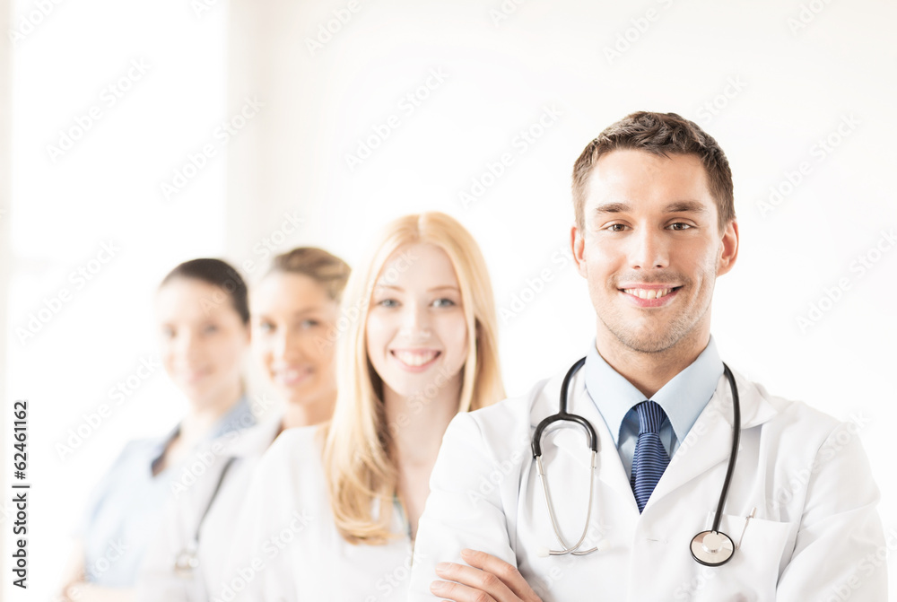 male doctor in front of medical group male doctor in front of medical group