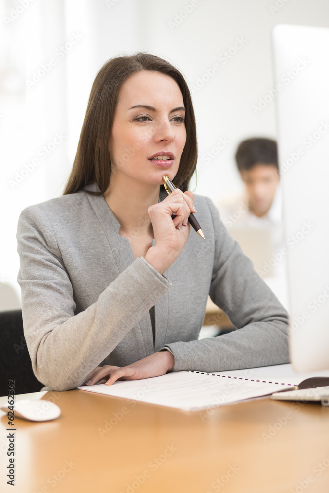 Portrait of businesswoman working on computer in office Portrait of businesswoman working on computer in office
