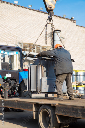 Industrial Worker unloading Complete Transformer Substation © Fotolia RAW