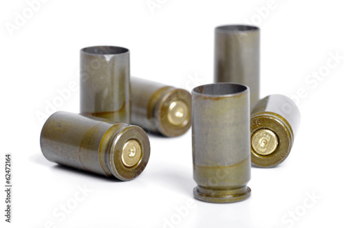 Empty 9mm bullet casings over white background