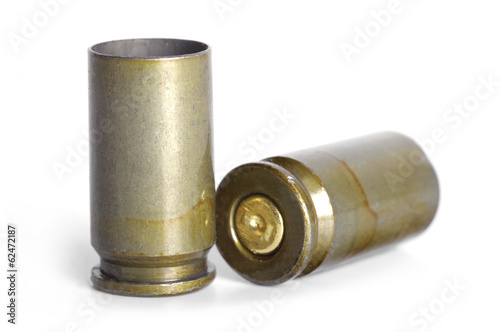 Empty 9mm bullet casings over white background