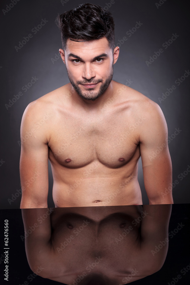 naked young man at his desk naked young man at his desk
