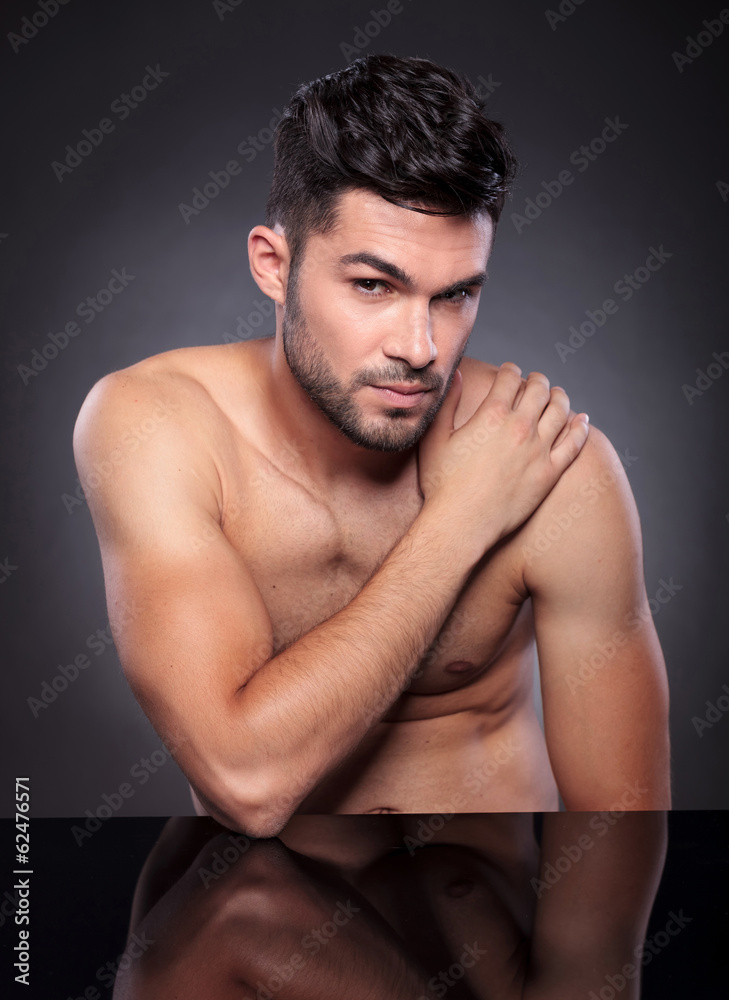 naked young man with hand on shoulder naked young man with hand on shoulder