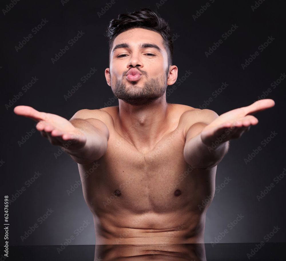 Obraz premium naked young man blows kisses