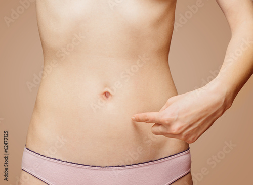 Woman points to the stomach