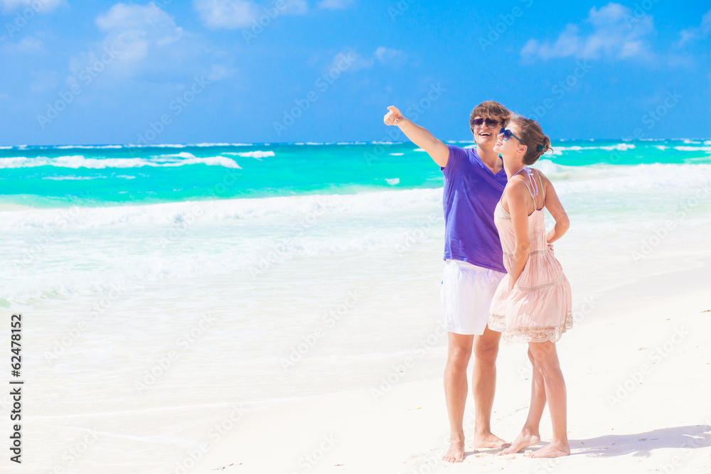 couple in bright clothes on tropical beach in Thailand. gesture couple in bright clothes on tropical beach in Thailand. gesture