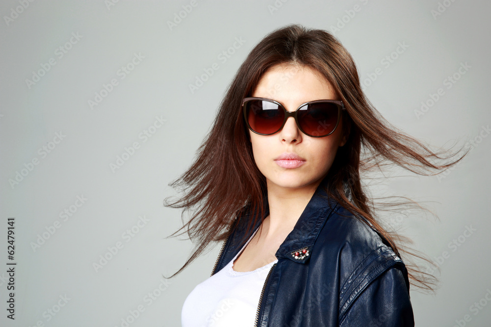 model in leather jacket and sunglasses on gray background model in leather jacket and sunglasses on gray background