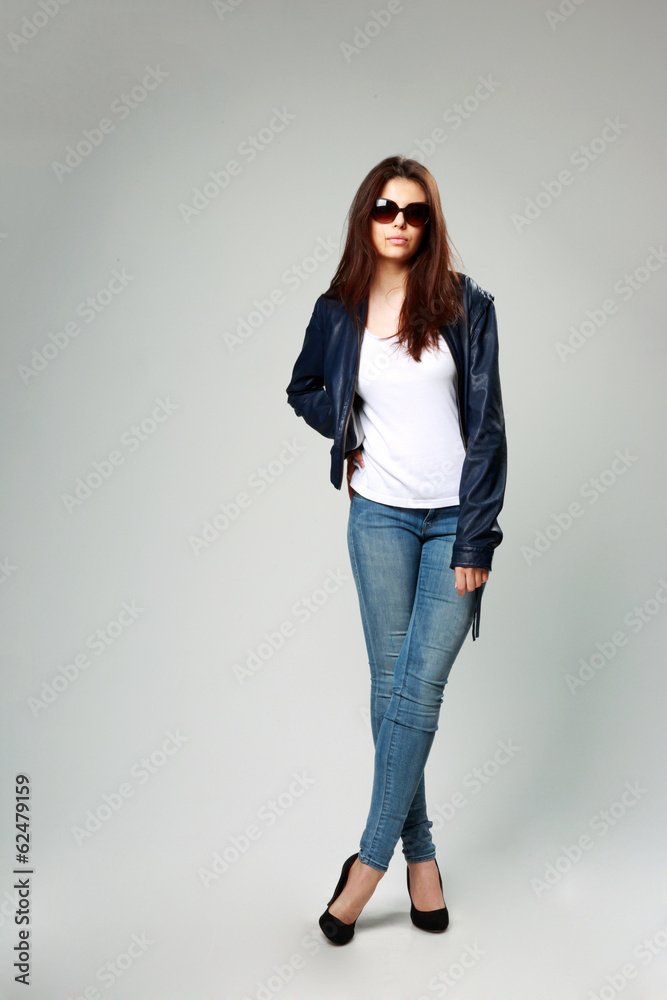 model in leather jacket and sunglasses on gray background model in leather jacket and sunglasses on gray background