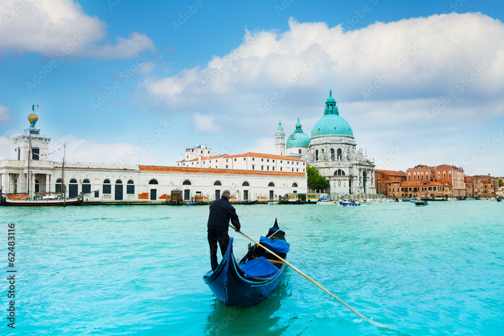 Gondola and gondolier in central Venice