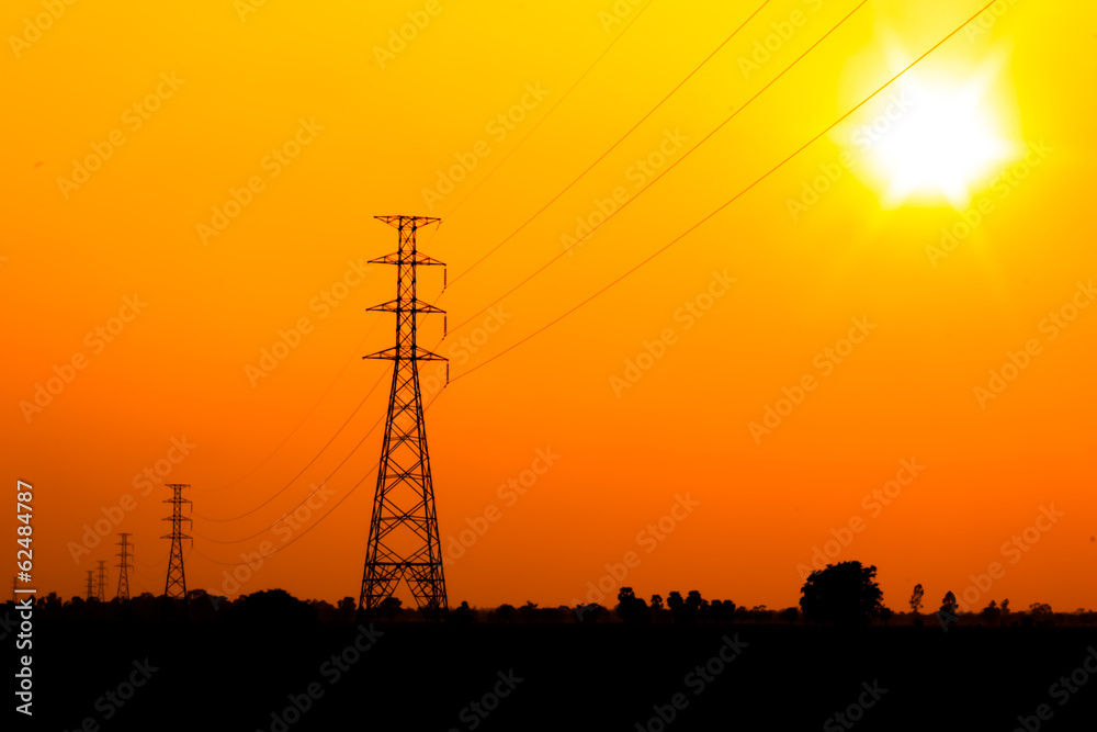 Fototapeta premium High voltage power pole middle of a cornfield with orange sky