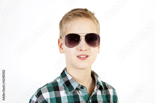 Smiling boy in sunglasses. Youth fashion.