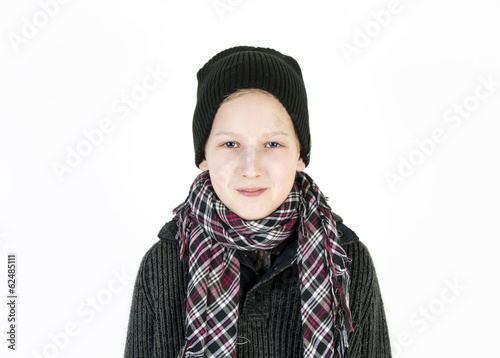 Smiling boy in a cap and a scarf. Youth fashion