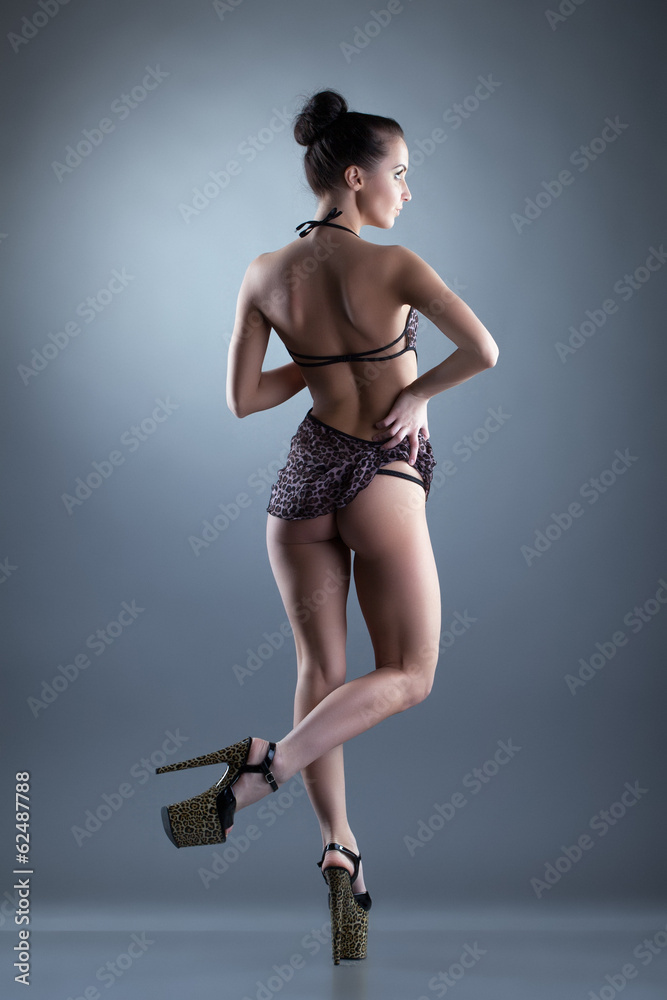 Fototapeta premium Alluring slim girl posing in erotic negligee