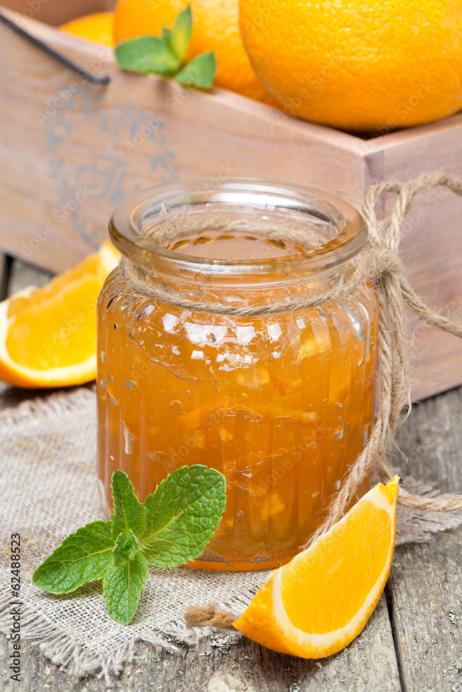 orange marmalade in a glass jar, vertical orange marmalade in a glass jar, vertical