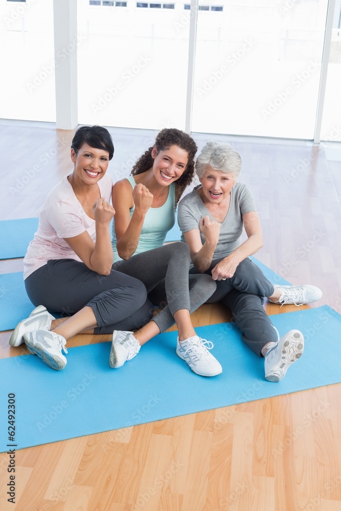 Full length portrait of happy women in yoga class