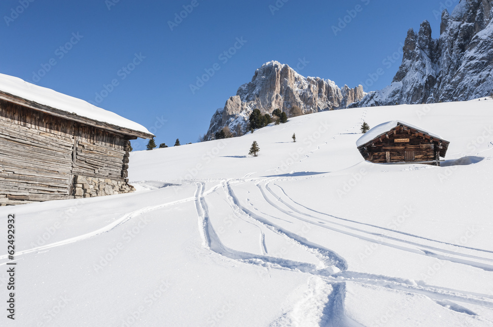 Ski marks in the snow, between Mountain huts, against Dolomites and Blue Sky