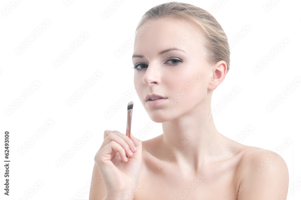 Girl with eyelid brush, isolated on white