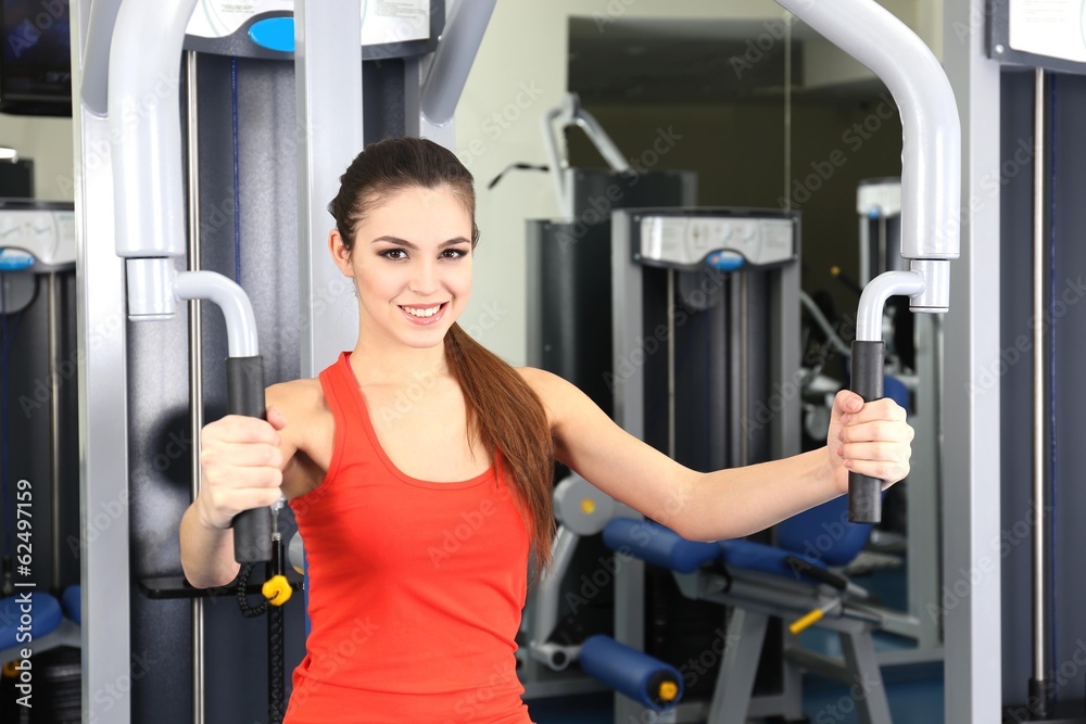 Beautiful woman training with weights in gym Beautiful woman training with weights in gym
