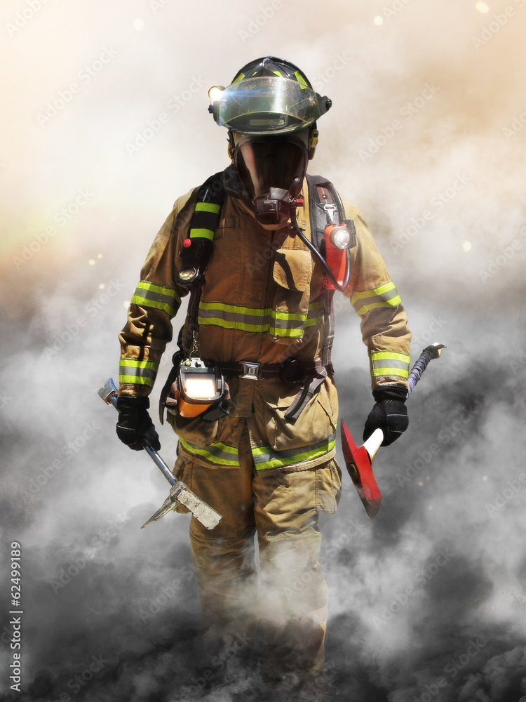 Fototapeta premium A firefighter pierces through a wall of smoke