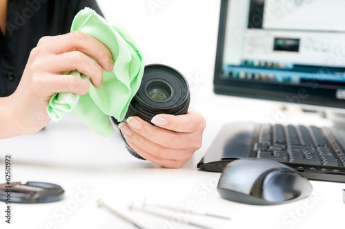Female engineer repairing camera lens