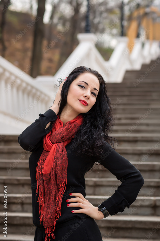 Fototapeta premium Beautiful Woman in warm autumn day on staircase