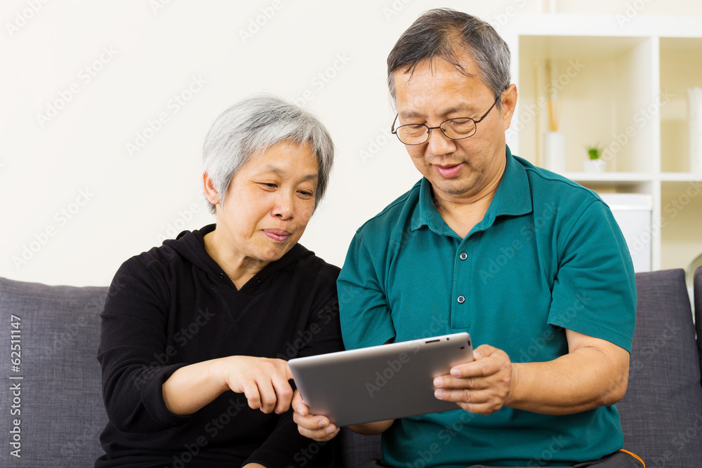 Asian couple using tablet together at home