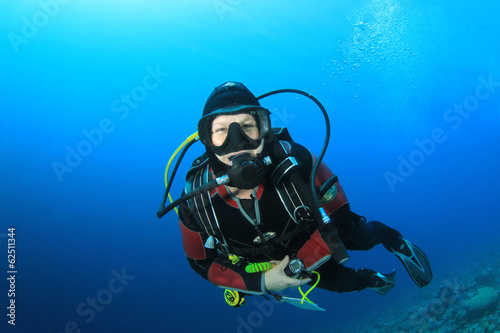 Happy woman scuba diving