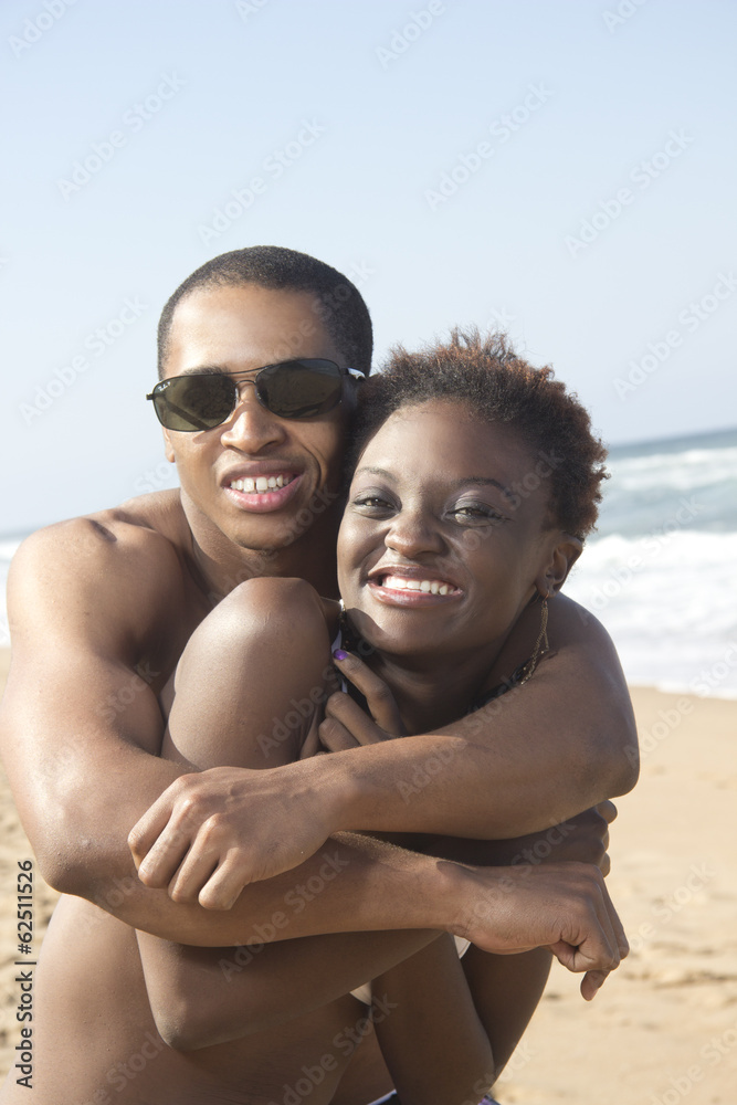 Cute young couple holding tight at beach Cute young couple holding tight at beach