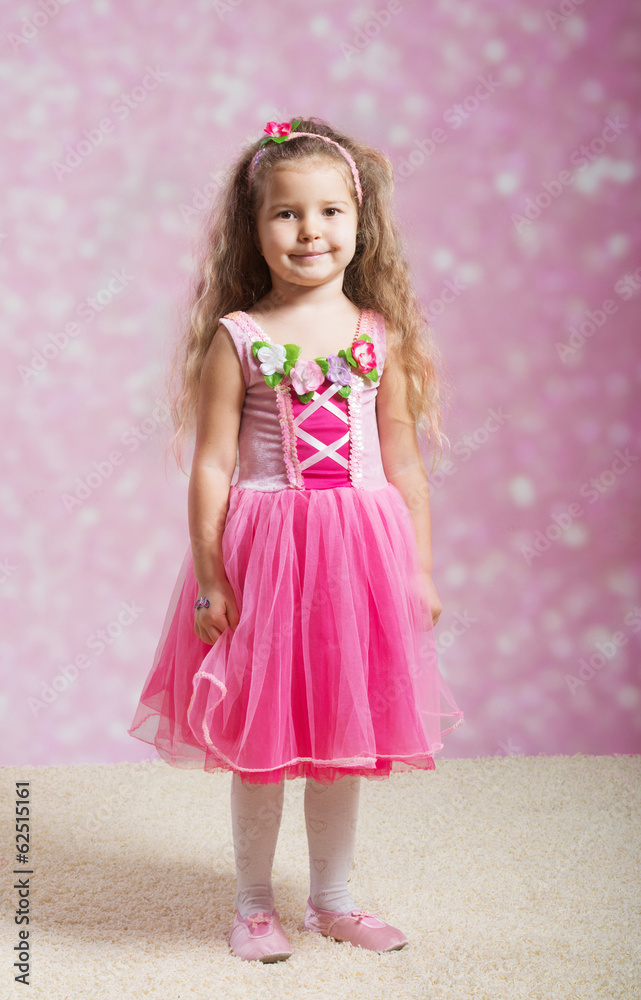 Full length portrait of a cute little lady in pink dress